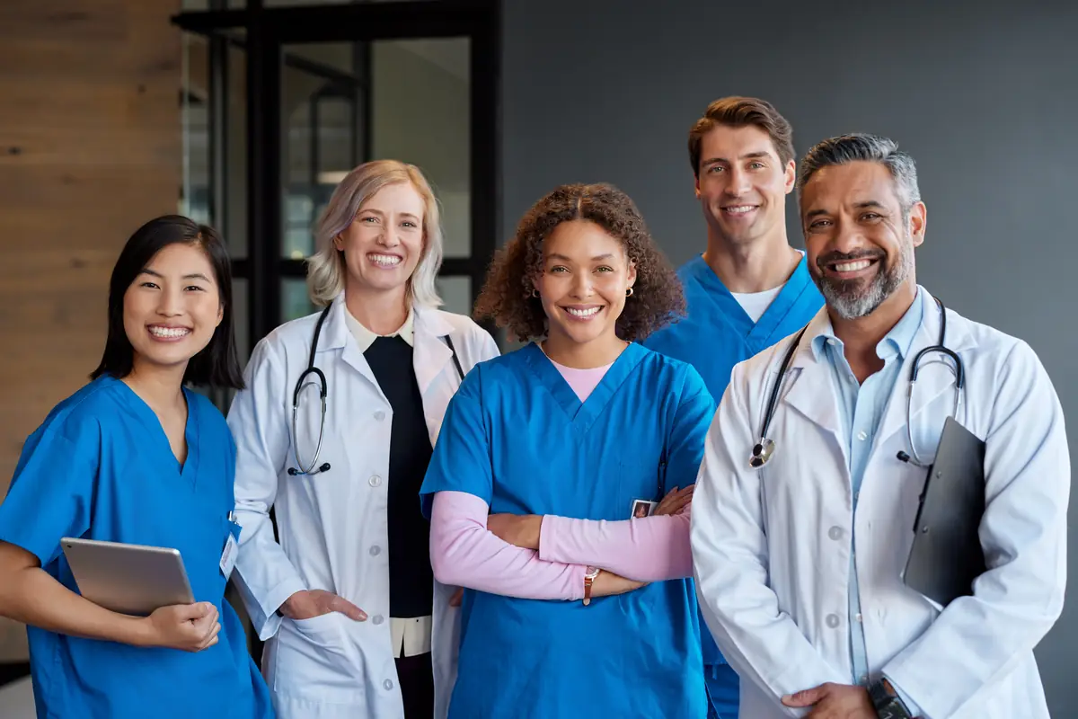 A team of smiling doctors and nurses